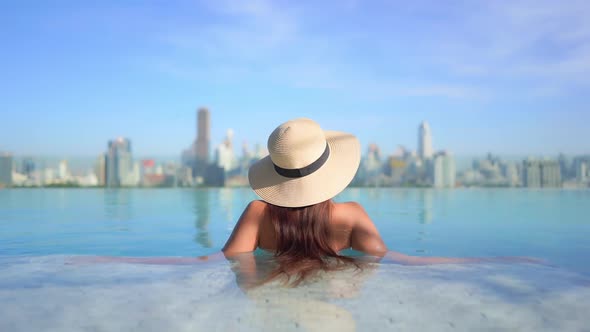 Young asian woman enjoy around outdoor swimming pool for leisure