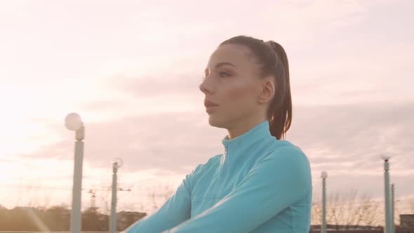 Young, beautiful and sporty woman having evening training outdoor.