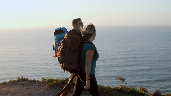 Happy Middle Aged Couple with Camping Backpacks