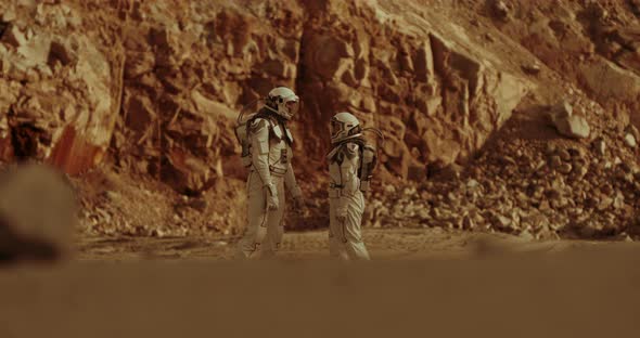 Astronauts Speaking Near Mountain Ridge on Mars