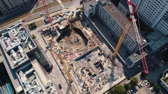 Construction Workers Building Housing Units or New Skyscrapers Between Two Buildings