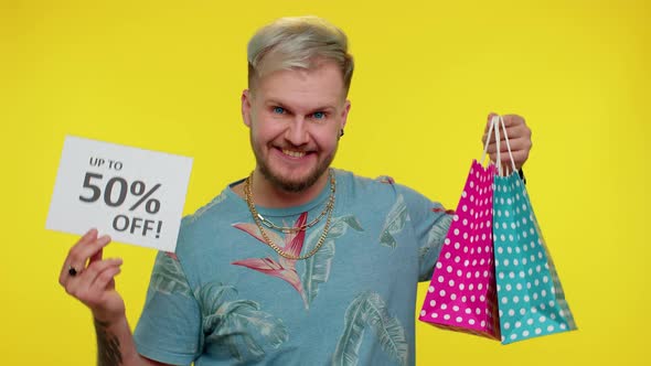 Cheerful Tourist Man Showing Shopping Bags and Up To 50 Percent Off Inscriptions Banner Black Friday