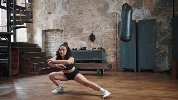 Sportive Woman Does Side Lunges Warming Up Before Boxing