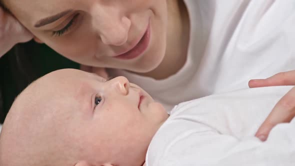 Happy Mother Lying with Baby