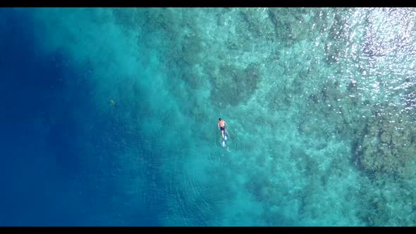 Teenage lovers tan on luxury coastline beach voyage by clear lagoon with clean sand background of th