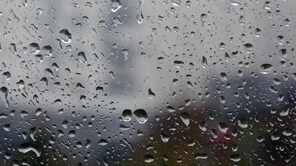 Window Glass In Drops Of Rain. Drops Run Down The Glass. alt