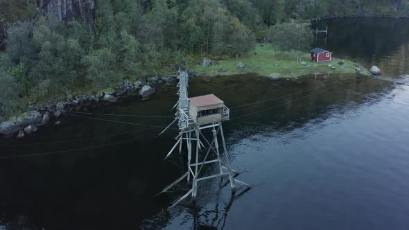 Aerial shot over Old salmon fishing hut in the middle of lake - Laksegilje, Norway