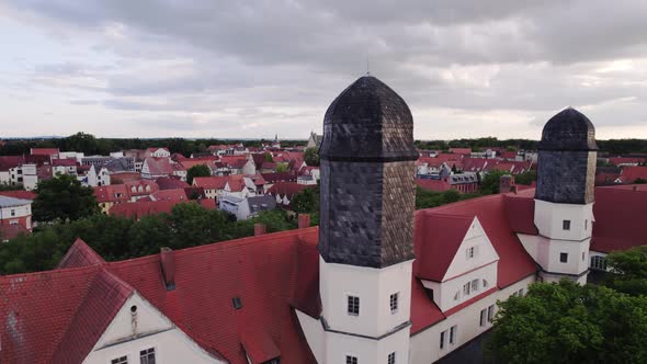 Rotating aerial shot of Schloss Köthen castle in Germany, showing the roof and 2 towers