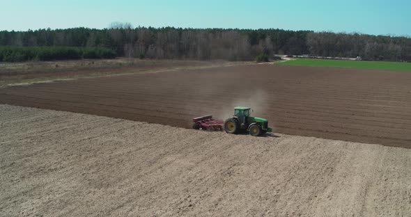 Tractor Cultivating Field at Spring Aerial View