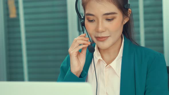 Businesswoman Wearing Headset Working Actively in Office