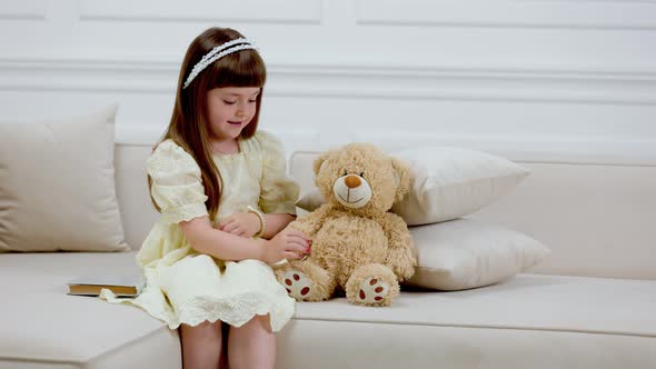 Girl Playing with Teddy Bear