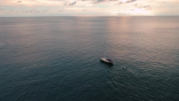 Colorful Sunset Above the Sea Surface with Sail Boat Aerial View Phuket Thailand