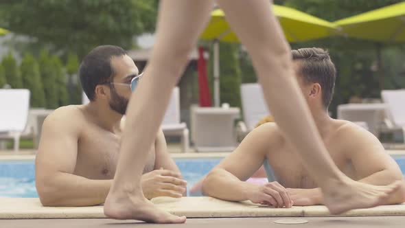 Portrait of Young Men Admiring Slim Female Legs Passing By. Handsome Middle Eastern and Caucasian