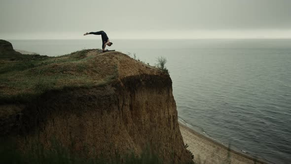 Beautiful Woman Bending Body to Foot Practicing Yoga Asana on Beach Hill