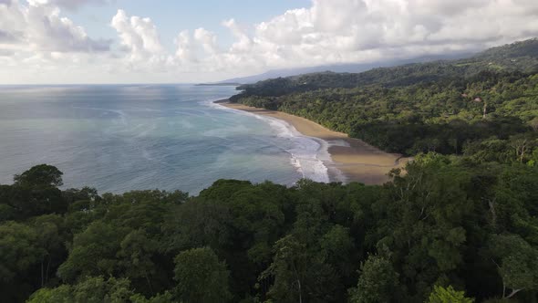 Aerial view of a beautiful empty Costa Rican coastline with sand beach