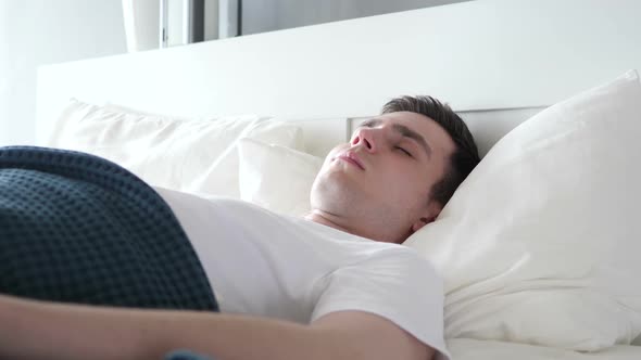 Close Up of Disturbed Man Sleeping in Bed