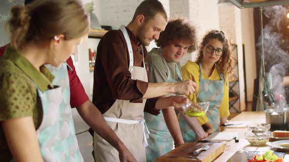 Chef Mixing Ingredients while Giving Cooking Master Class