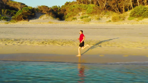 Man Runs Along the Water's Edge