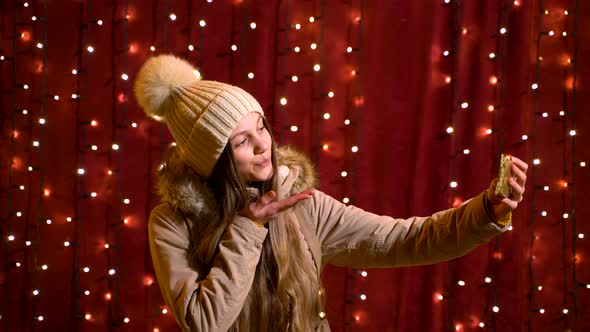 Beautiful teenager taking a selfie at Christmas market.