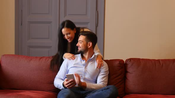 A young couple discussing content on a smartphone