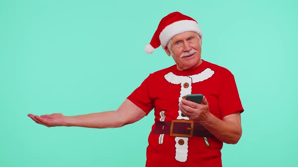 Grandfather Santa Christmas Tshirt with Mobile Phone Showing Pointing Empty Place Advertising Area