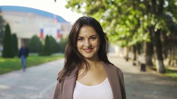 Beautiful Brunette Businesswoman In Business Clothes Walks In The City