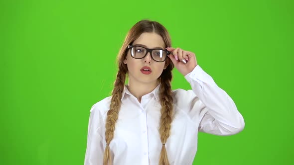 Schoolgirl Takes Off Her Glasses, She Is Tired. Green Screen. Slow Motion