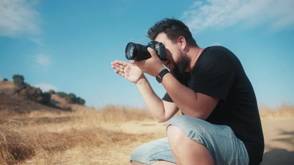 Professional Photographer Focused on Taking Pictures in Outdoor Nature Park