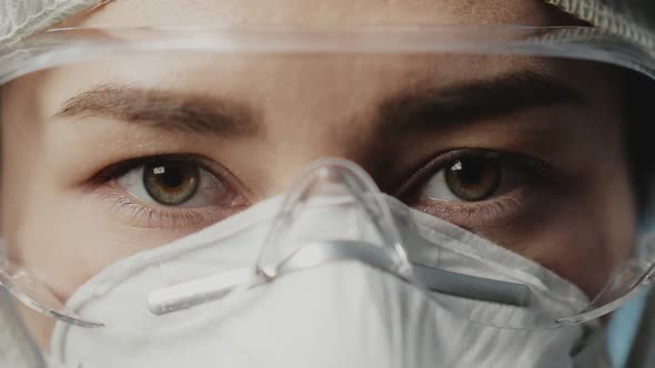 Portrait of Confident Doctor Woman Face, Close-up. Eyes with Safety Glasses and Protective Mask