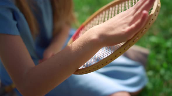 Closeup Girl Hand Touching Racket Strings