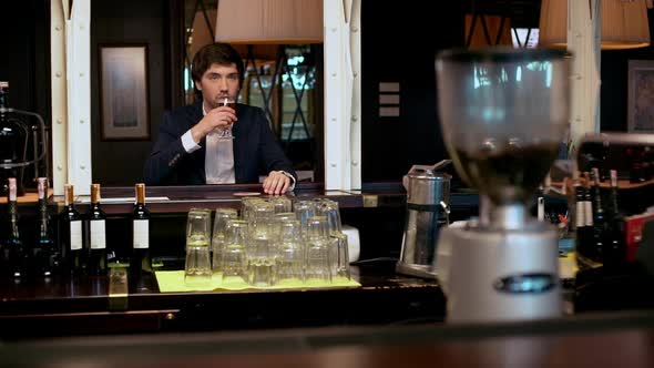 Young Successful Businessman Drinking Beer in Cafe