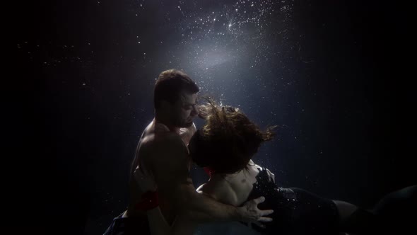 Lovers Are Floating Inside Darkness and Depth Underwater Shot of Loving Pair Slow Motion