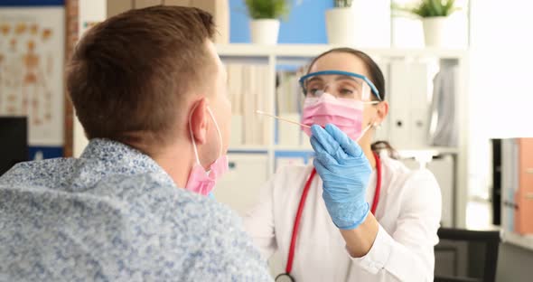 Doctor with Protective Medical Mask and Glasses Taking Swab From Nose at Clinic  Movie