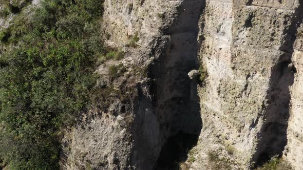 A large cliff and the surrounding environment in the andean mountains