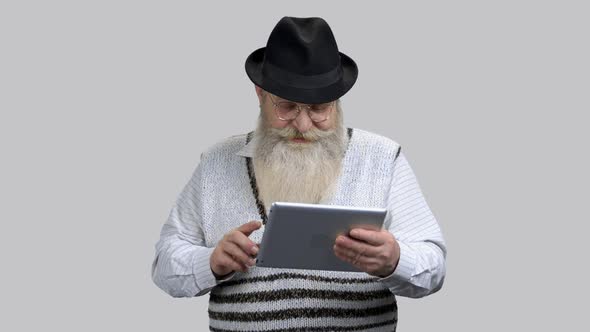 Old Retired Grandpa Starting Online Conversation Using His Tablet Pc