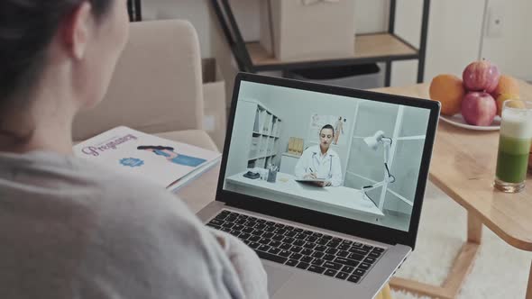 Pregnant Woman Having Consultation with Doctor on Web Call