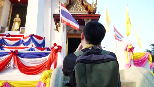 Young Asian Traveling Backpacker Taking Photos with DSLR Camera in Ayutthaya Province Thailand