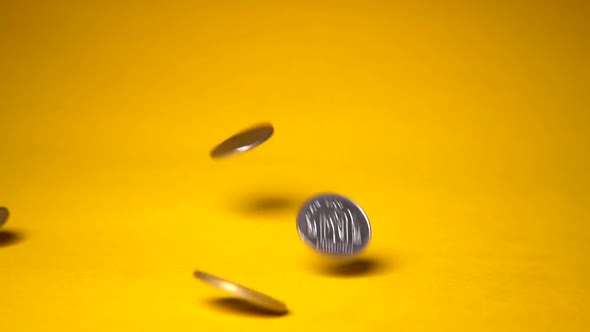 Falling Coins on Gold Background