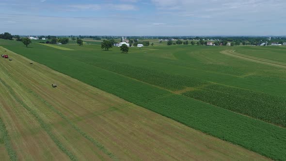 Aerial View of an Amish Farmer Harvesting His Crop with 4 Horses and Modern Equipment