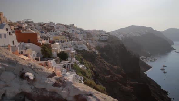 Wide shot of Oia, Santorini. Looks like hanging of the steep cliffs over the majestic Santorini seas