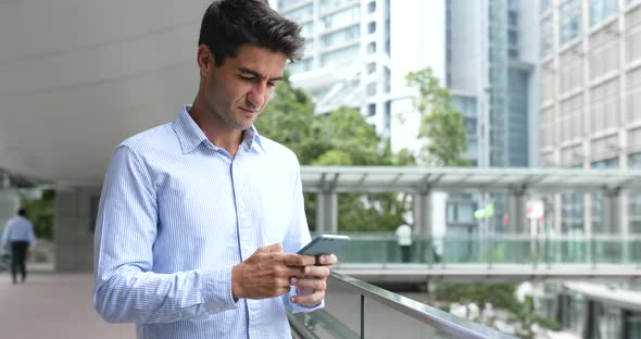 Man use of mobile phone in Hong Kong city