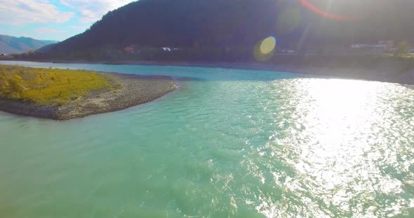 Low Altitude Flight Over Fresh Fast Mountain River with Rocks at Sunny Summer Morning.