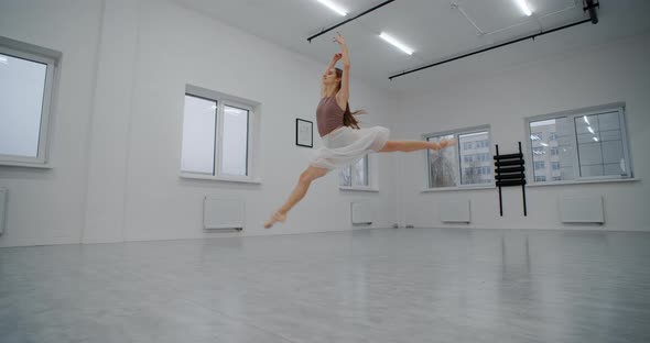 Ballerina in Pointe Shoes Runs Through the Dance Room and Jumps Several Times in Slow Motion Dance