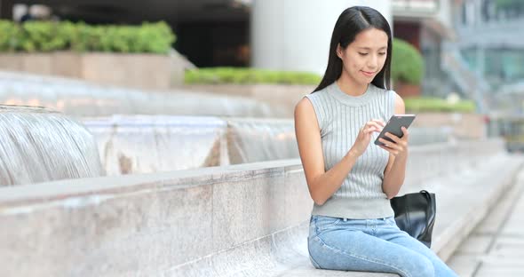 Woman Using Smart Phone in Street