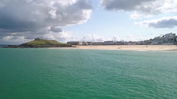 Fly in Pan up establishing shot overlooking Porthminster Beach St Ives Cornwall England UK