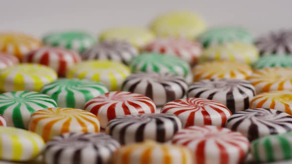 Rotating shot of a colorful mix of various hard candies 