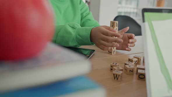 African American student doing activity playing block wooden for development together.