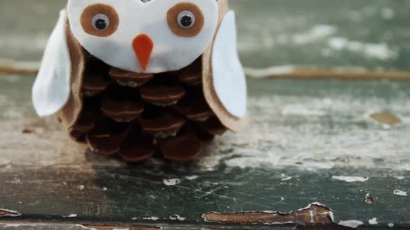 Pine cone owl on wooden table