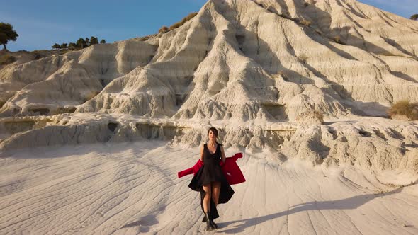 Girl Dancing With Red and Black Dress and Boots in the Mountains