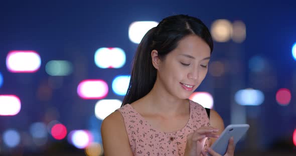 Woman use mobile phone at night
